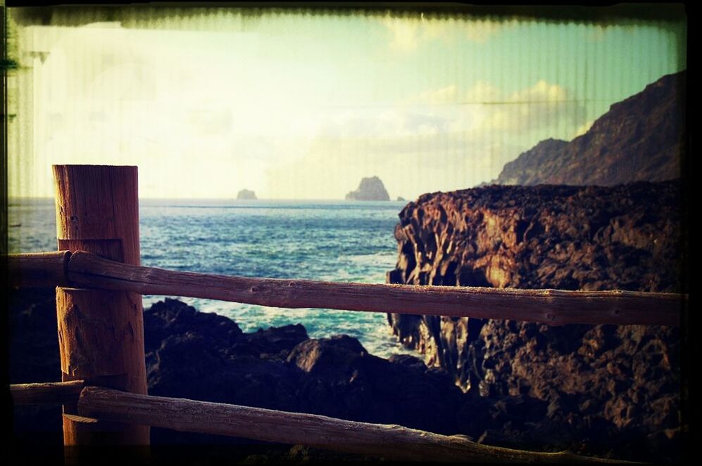 sea, water, horizon over water, transfer print, tranquil scene, scenics, tranquility, sky, beauty in nature, auto post production filter, nature, rock - object, idyllic, railing, beach, rock formation, calm, rock, shore, coastline