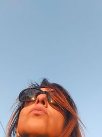 Portrait of beautiful woman against clear sky