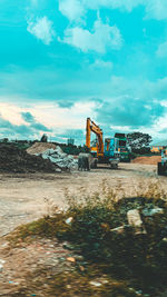 Construction site by road against sky