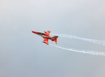 Low angle view of airplane flying against clear sky