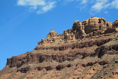 Low angle view of old ruins against blue sky