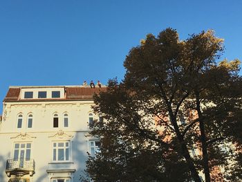 Low angle view of built structure against clear blue sky