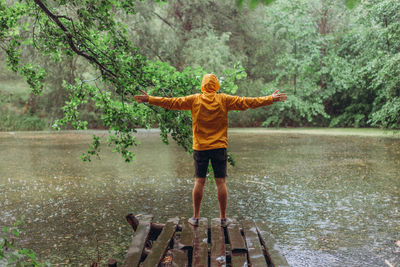 Full length of man standing by lake