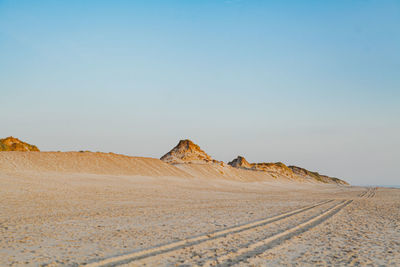 Scenic view of desert against clear sky