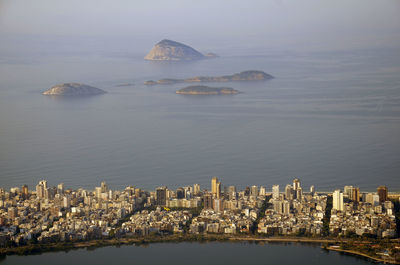 Aerial view of city amidst sea