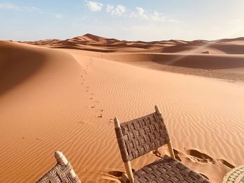 Sand dunes in desert against sky