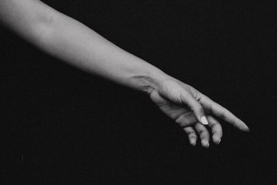 Close-up of hand against black background