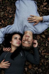 Couple lying on forest ground