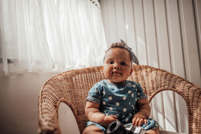 Portrait of cute girl sitting at home