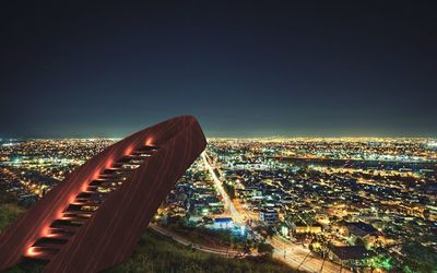 Aerial view of city lit up at night