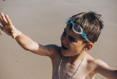 Close-up of playful boy at beach
