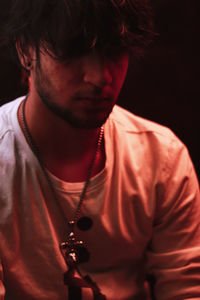 Close-up of young man against black background