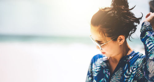 Portrait of woman wearing sunglasses against sky