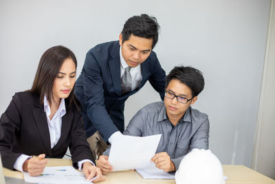 Colleagues discussing business plan in office