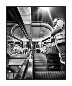 Rear view of people on escalator