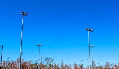 Low angle view of floodlight against clear blue sky