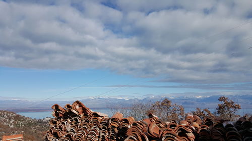 Roof tiles against sky