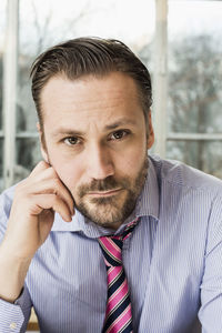 Portrait of confident mid adult businessman in office