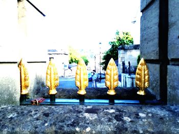 Close-up of yellow lantern hanging outside temple against sky