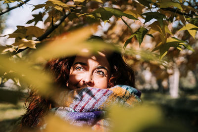 Portrait of young woman with leaves