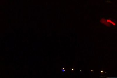 Illuminated lights against clear sky at night