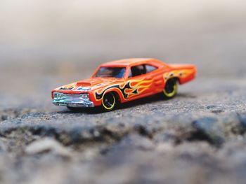 Close-up of toy car on rock