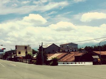 Houses against cloudy sky