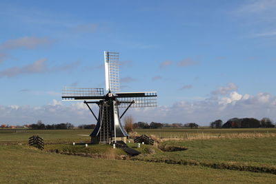 Traditional windmill on field