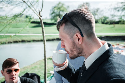 Portrait of young man drinking coffee