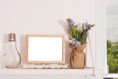 Flower vase on table at home