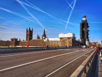 View of city buildings against blue sky