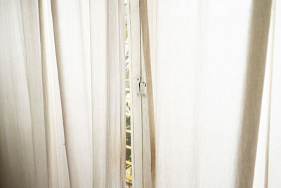 Close-up of curtain hanging against wall