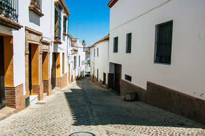 Narrow street amidst buildings against sky