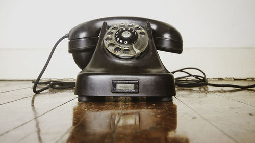 Close-up of old telephone on table