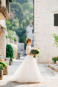 Close-up of woman holding white flower bouquet