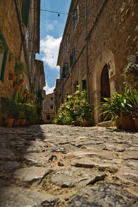 Narrow alley amidst old buildings in city