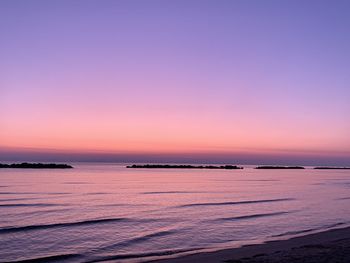 Scenic view of sea against romantic sky at sunset