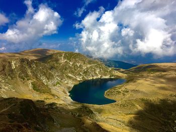 View of calm countryside lake against mountain range