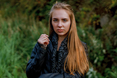 Portrait of young woman standing outdoors