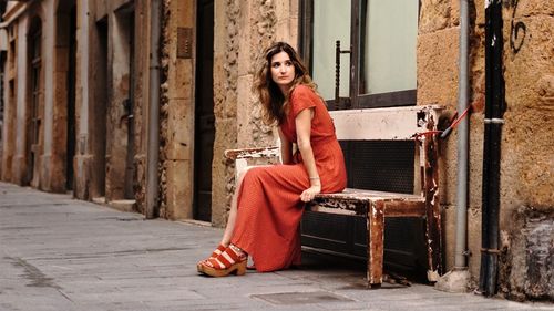 Portrait of woman sitting outdoors