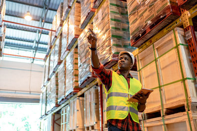 Low angle view of man working on building