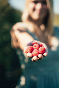 Close-up of woman holding raspberries