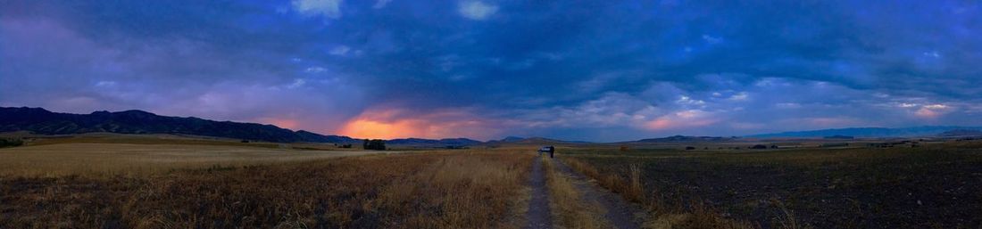 Panoramic view of field against sky during sunset