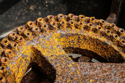 Close-up of rusty chain on rock