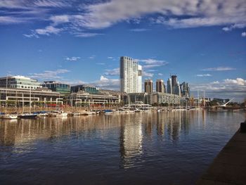 Modern buildings by city against sky