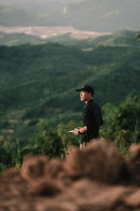 Young man standing on rock