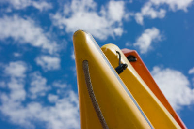 Low angle view of yellow playground against sky