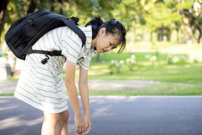 Full length of a girl with umbrella on road