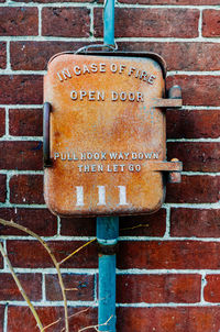 Close-up of text on brick wall