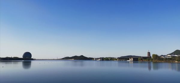 Scenic view of lake against clear blue sky